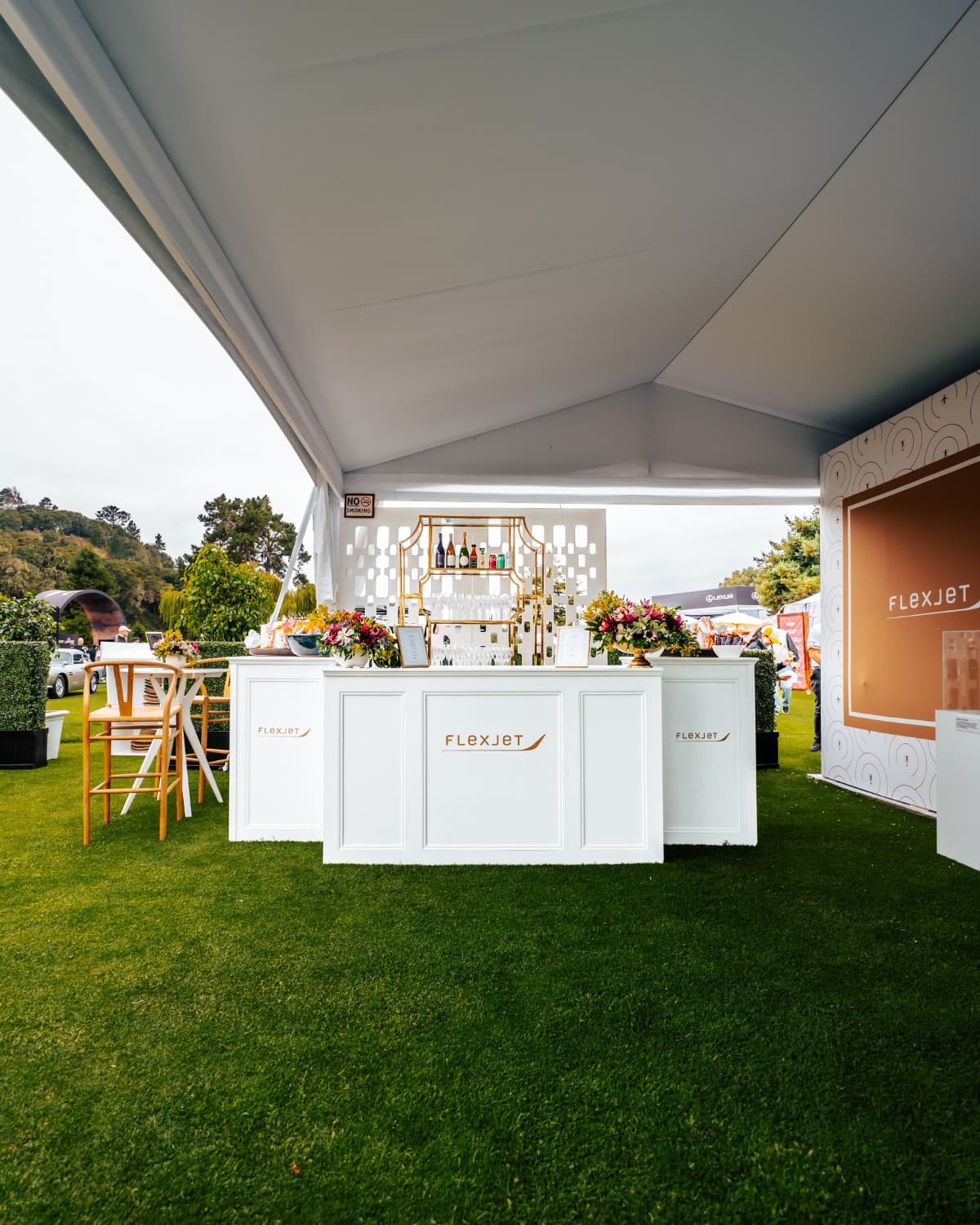 Premium event hospitality activation, branded bar setup at a luxury concours